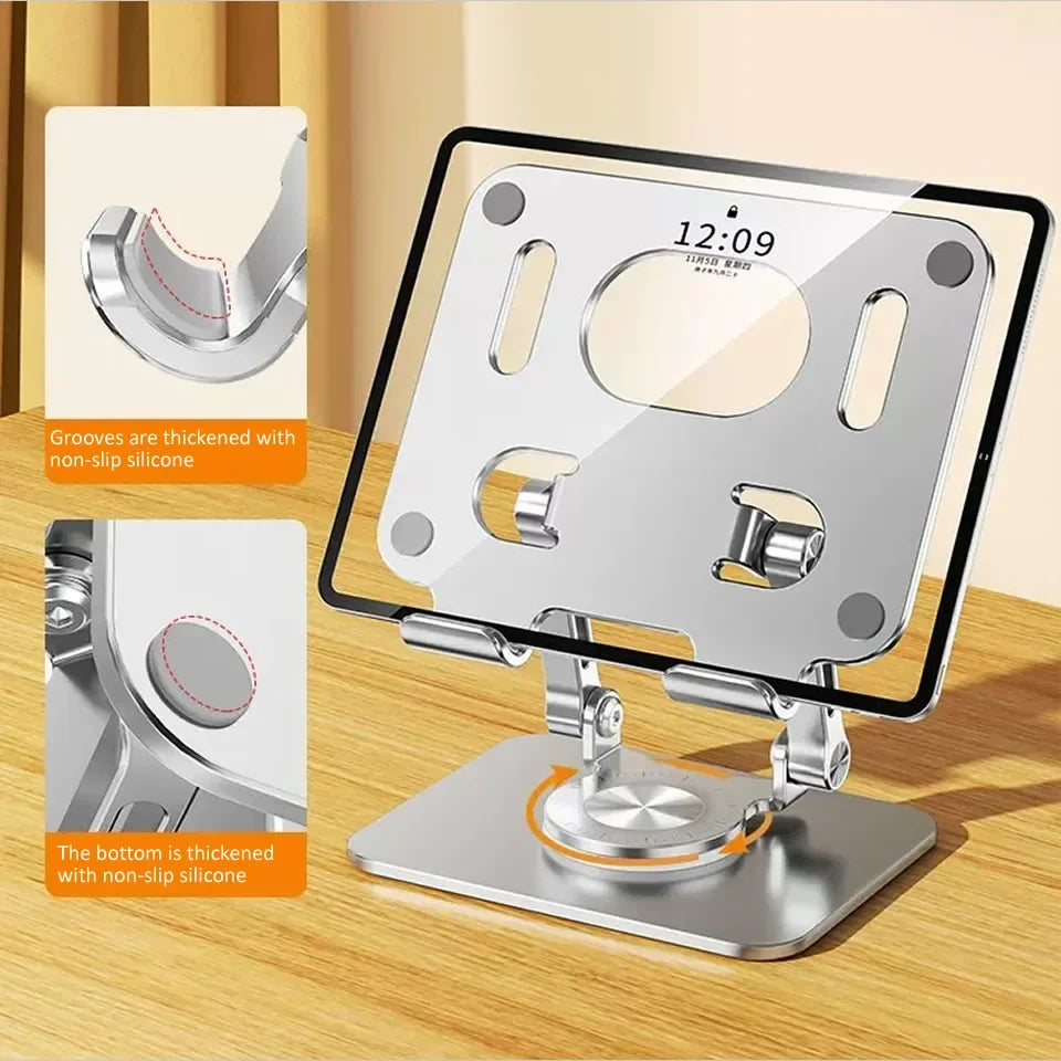 A silver tablet stand with a rotating base and non-slip silicone grooves for secure placement.