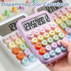 A hand holds a pink dopamine color calculator displaying the number 123456789012.