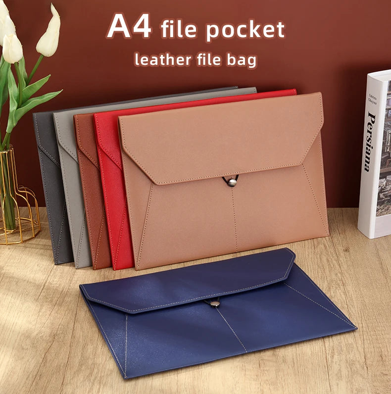 A collection of leather file bags and a navy blue folder are displayed on a wooden surface.