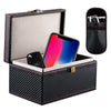 A black leather case with a lid protecting a smartphone and a key fob.