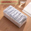 A white plastic box filled with seven small transparent boxes and one large white box for cable organization.