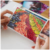 A hand holds a clear thermal laminating pouch filled with colorful vegetables like peppers, carrots, and corn.