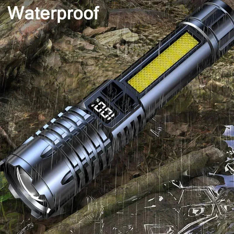 A silver tactical LED flashlight with a yellow lens is shown in a wet, outdoor environment.