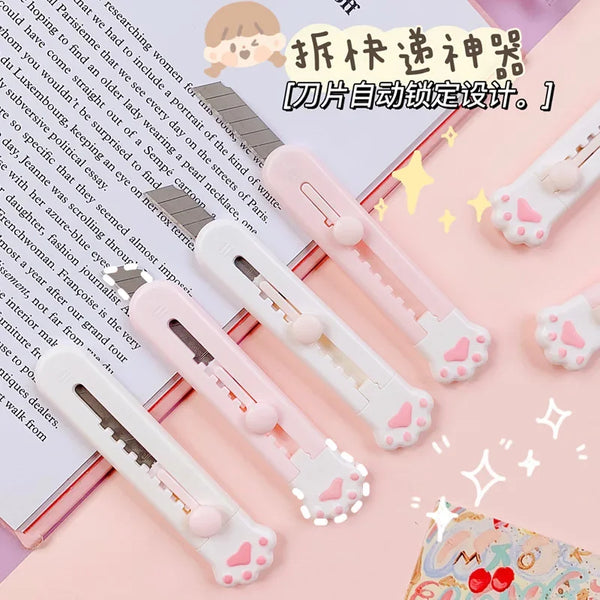 A collection of adorable cat paw mini cutters for mail and crafts shown in various pink and white colors.