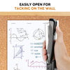 A hand is using a heavy-duty metal stapler to tack a piece of paper onto a wooden board.