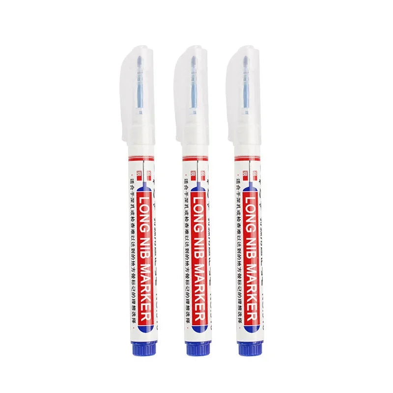 A set of five white permanent paint marker pens with blue tips and caps.