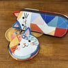 A patchwork cat face coin purse with a zipper, featuring various colored fabric pieces and a cat design.