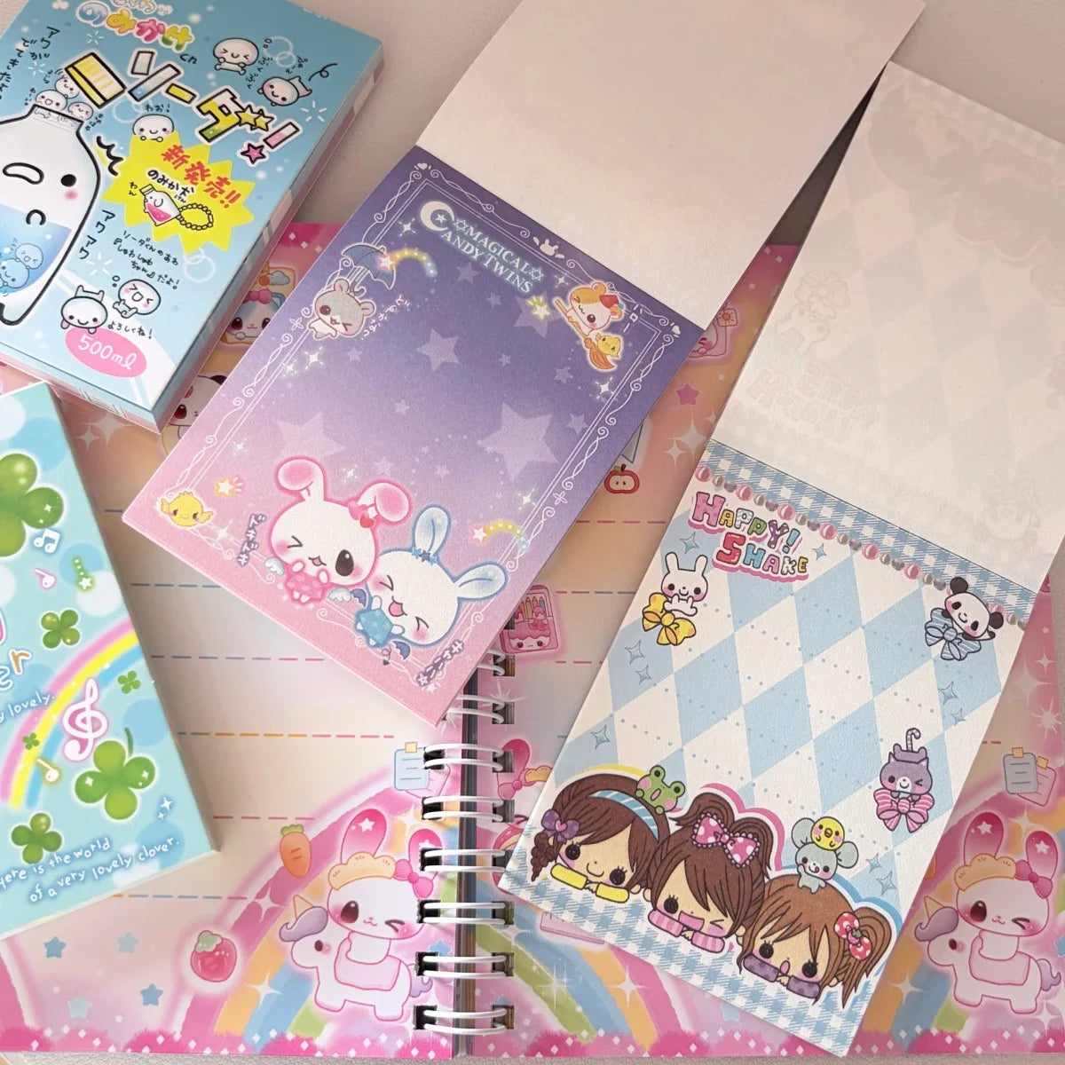A collection of colorful memo pads and stationery featuring cute characters and decorative patterns.