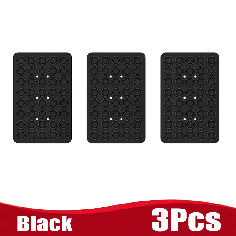 Three black silicone suction cup phone holders arranged side by side.