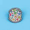 An enamel pin featuring various stylized microorganisms and the text What doesn't kill you mates and tries again