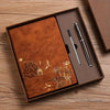 A luxury PU leather notebook set in a brown box with a leather-bound notebook and two metallic pens.