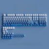 A close-up view of a keyboard featuring gradient gray double shot PBT keycaps with side printing.