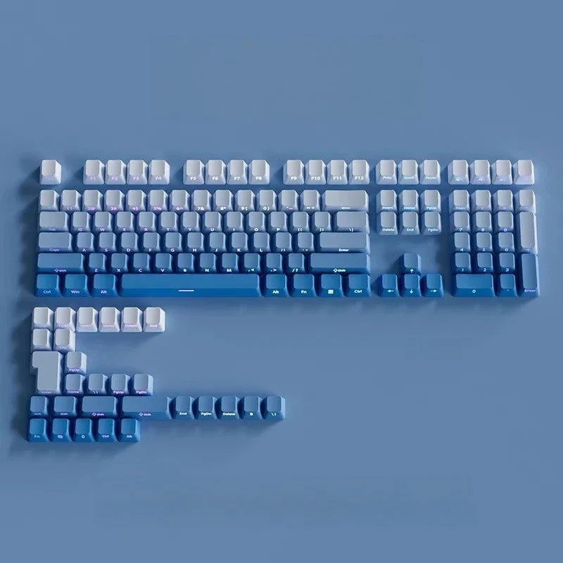 A close-up view of a keyboard featuring gradient gray double shot PBT keycaps with side printing.