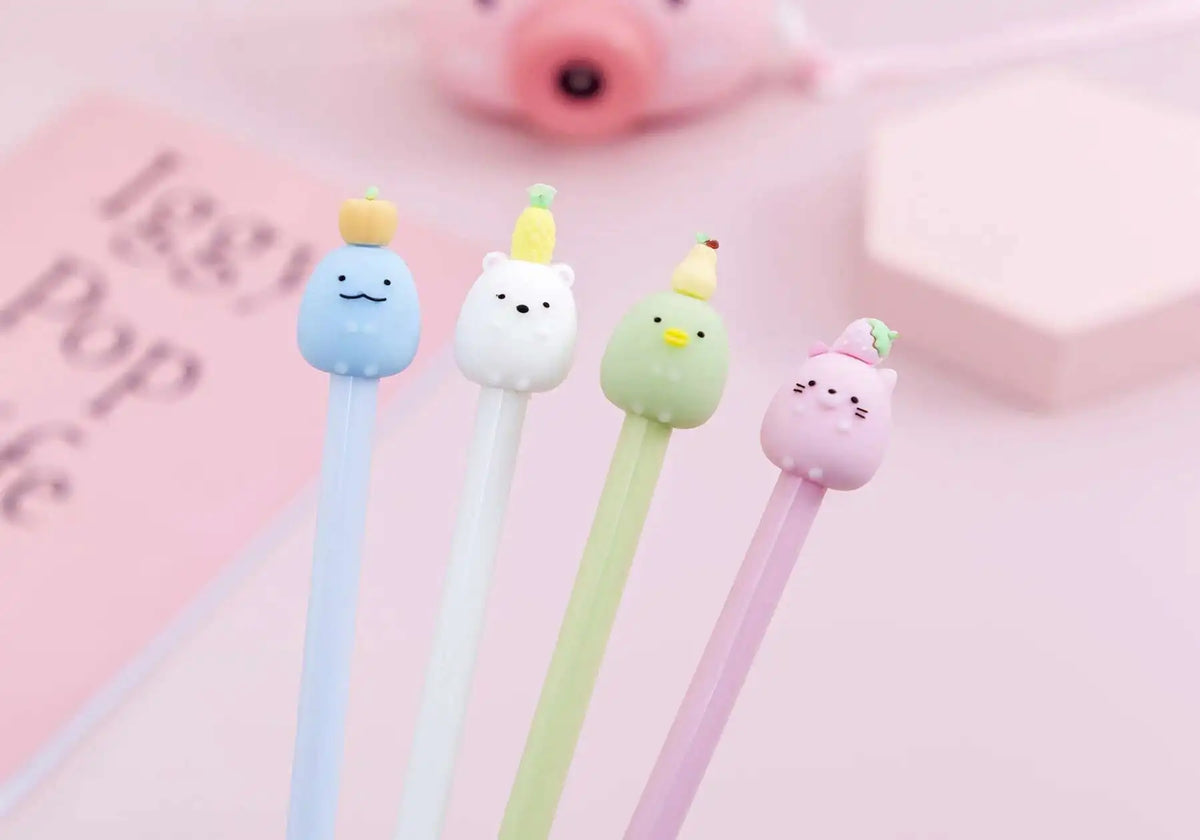 A collection of cute cartoon fruit gel pens in pastel colors, including blue, white, green, and pink.