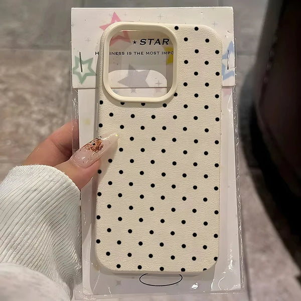 A clear plastic package shows a white polka dot textured phone case with a soft-touch grip.