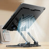 A black adjustable dual rod tablet and phone stand is shown on a wooden surface.