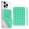 A white smartphone case with a green silicone suction cup holder and an accompanying green silicone phone grip.