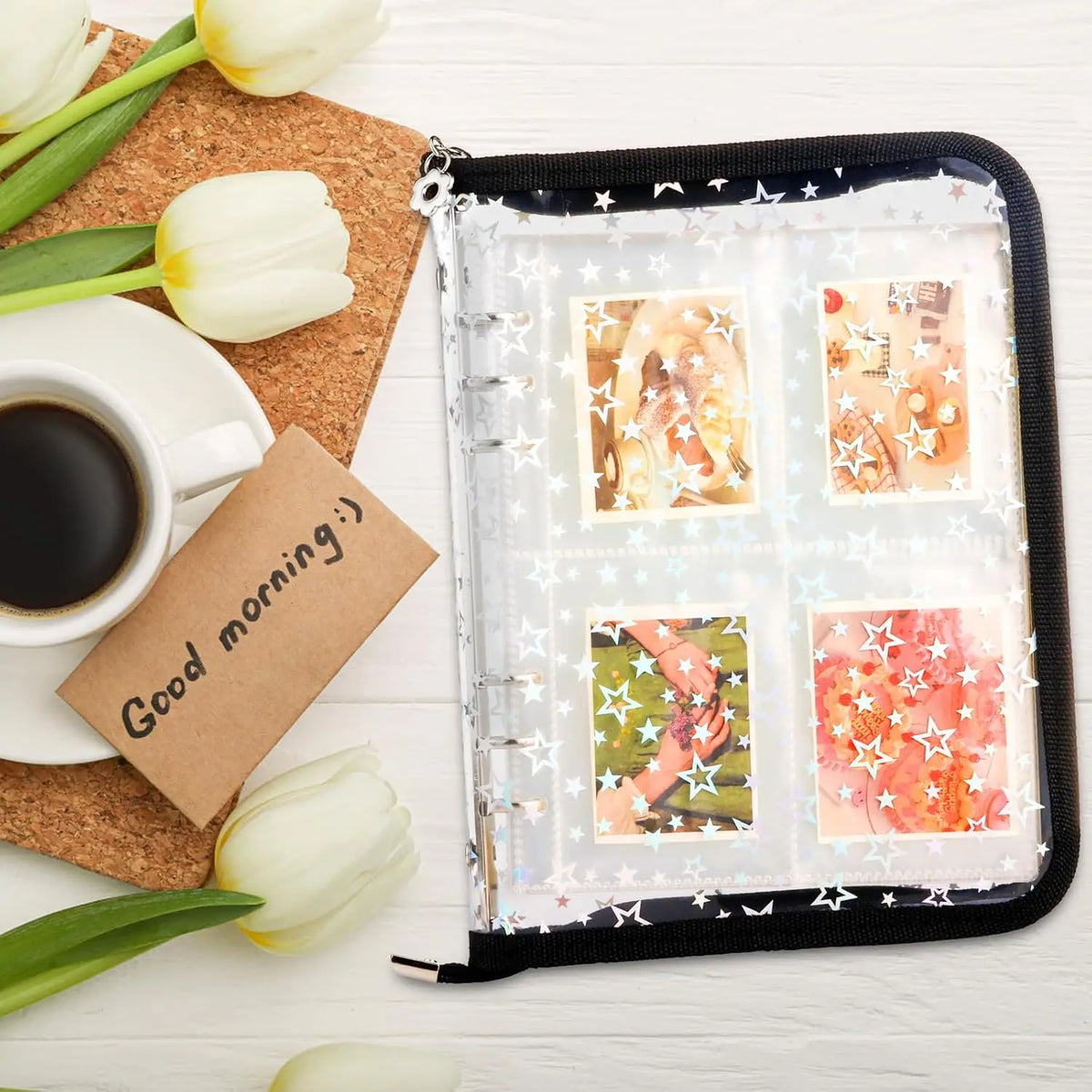 A clear A5 sticker organizer binder with black cover and multiple storage pockets, surrounded by white tulips.