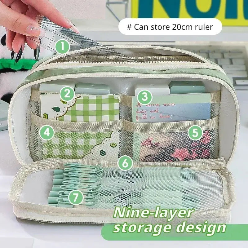 A light green pencil case with a transparent flip pocket showing various stored items and a multi-layer storage design.