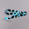 A blue and black patterned cartoon cat card holder lanyard with a neck strap.