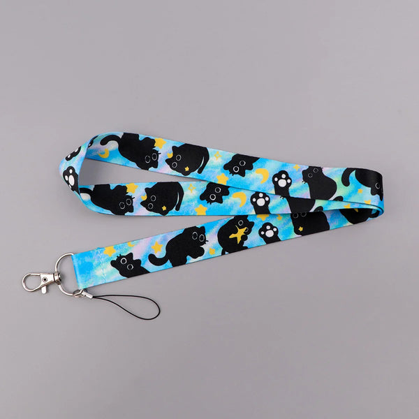 A blue and black patterned cartoon cat card holder lanyard with a neck strap.