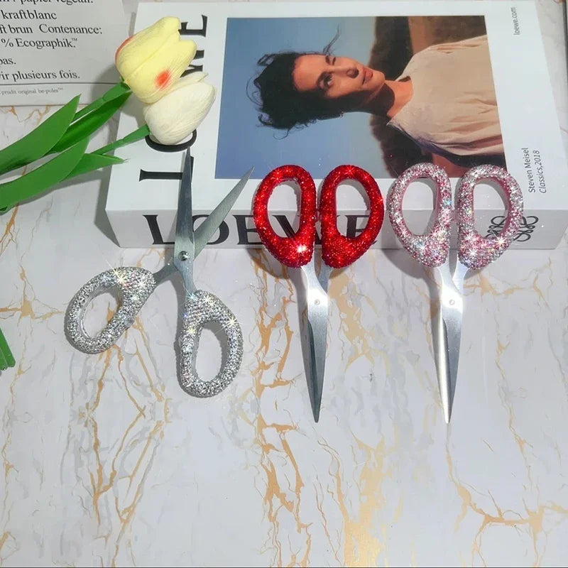 A set of luxury rhinestone crafting scissors and a yellow flower on a box.