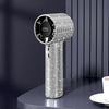 A silver sparkling diamond portable handheld fan with an LED display standing on a dark surface.