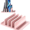 A pink vertical laptop stand organizer holding three smartphones and a tablet.