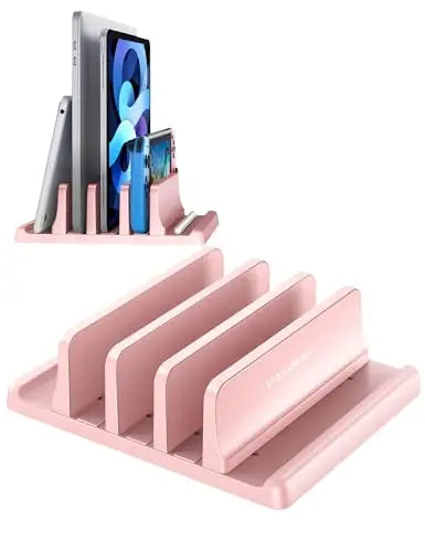 A pink vertical laptop stand organizer holding three smartphones and a tablet.
