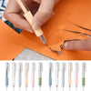 A hand is using a precision utility knife to cut an orange piece of paper, with a set of precision utility knives displayed b