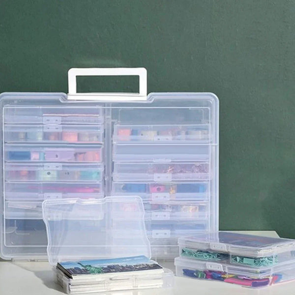 A clear plastic photo storage box organizer with multiple compartments and stacked photo albums.
