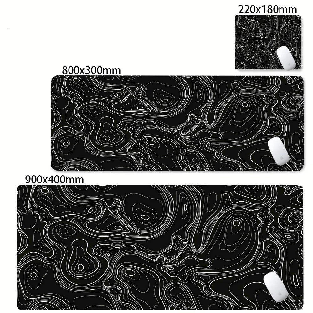 Black abstract desk mat featuring white contour lines and a white mousepad.