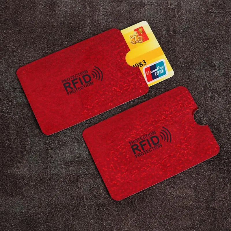 A set of five red RFID protection cards and a yellow UnionPay card displayed on a dark fabric surface.