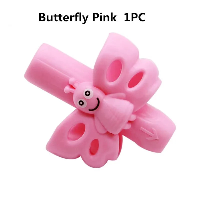 A single pink silicone butterfly pencil grip for children's handwriting aid.