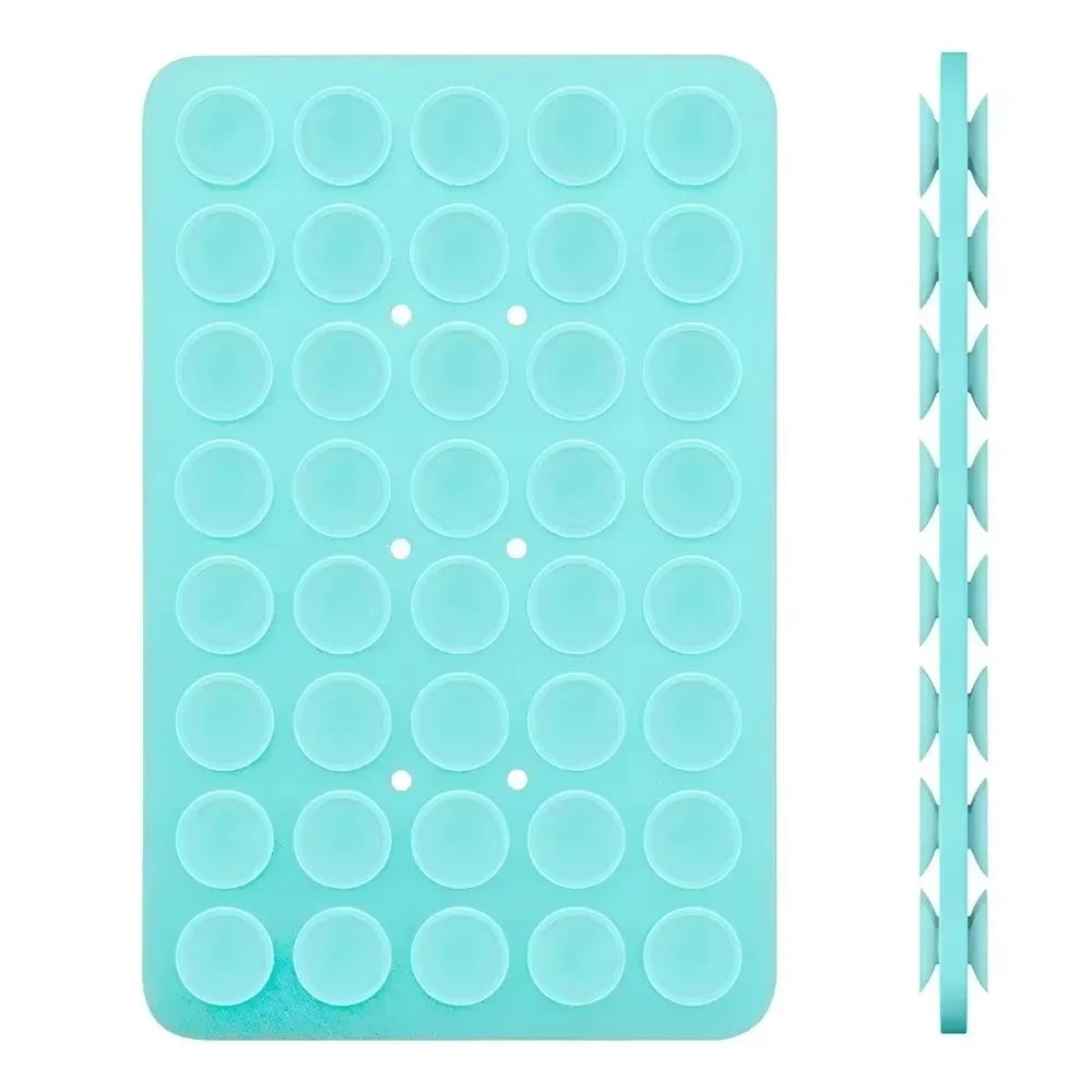 A teal double-sided silicone phone mount grip with multiple circular grips.