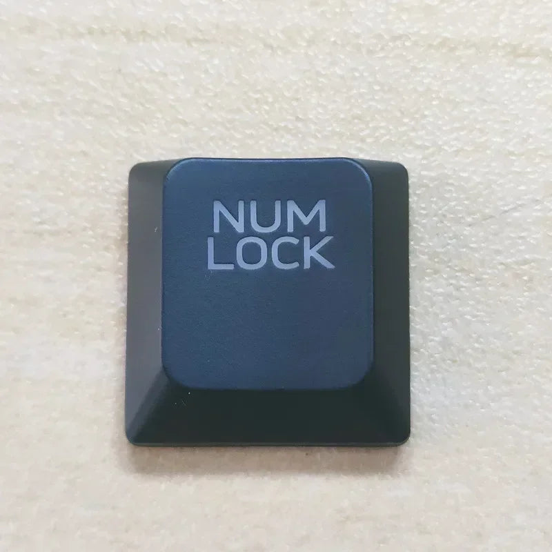 A dark blue mechanical keycap labeled NUM LOCK for a Dell Alienware keyboard.