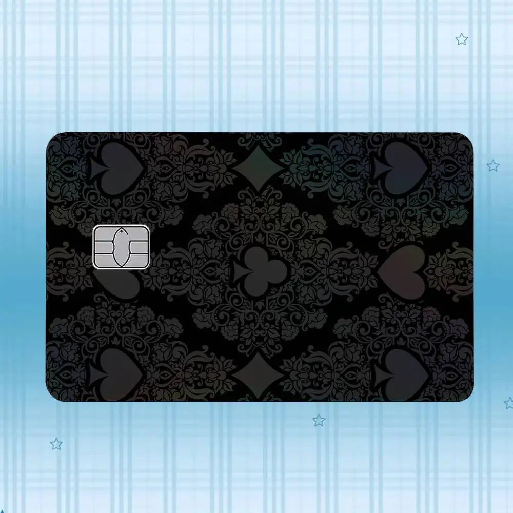 A black plastic card featuring a damask pattern and a square chip, set against a light blue striped background.