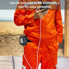 A person wearing orange workwear is holding a black adapter attached to their waist.