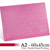 Pink A2 cutting mat with grid guides and decorative patterns for crafting