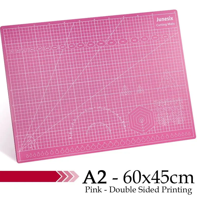 Pink A2 cutting mat with grid guides and decorative patterns for crafting