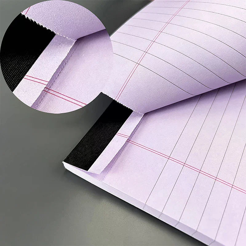 A close-up of a tearable lined writing pad in light purple with black accents, shown at an angle.