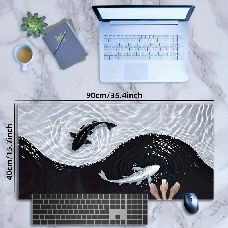 A gaming mouse pad featuring a black and white koi pattern with fish silhouettes, placed next to a laptop and a computer mous