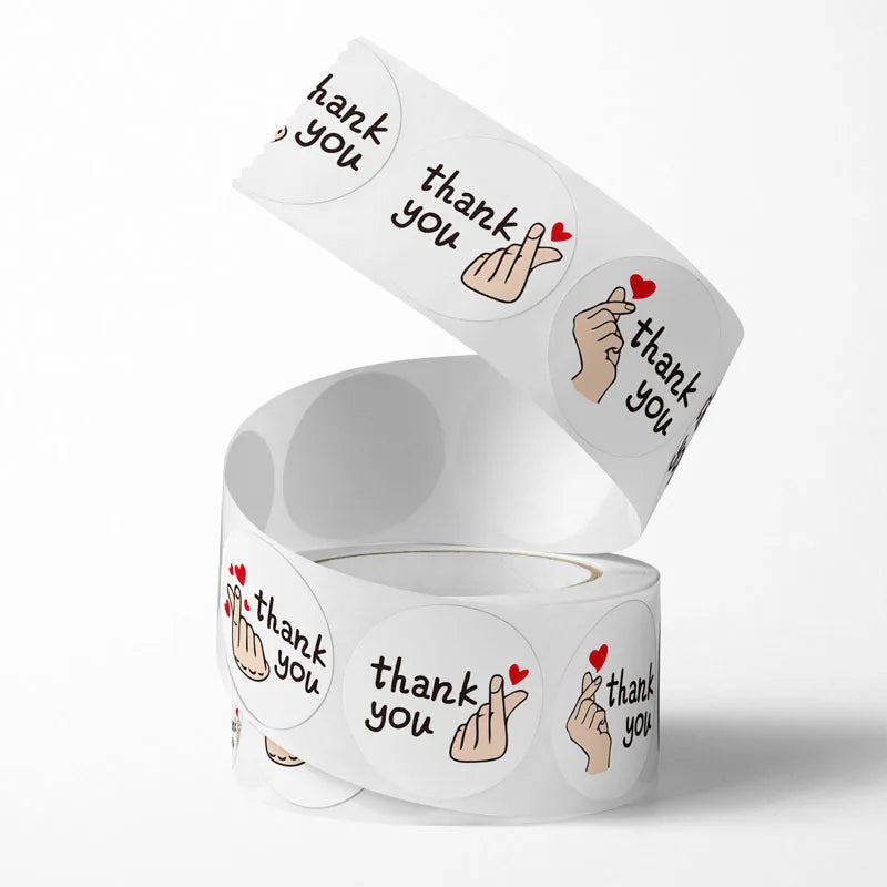 A set of thank you stickers featuring a red heart design, shown in various angles.