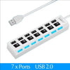 A white 7x Ports USB 2.0 hub splitter with a cable connected to the side.