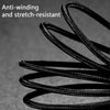 A close-up of a black braided charging cable coiled and stretched against a dark gray background.