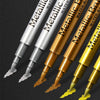 A close-up view of several metallic brush marker pens in various colors and finishes.