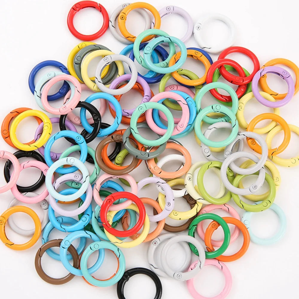 A collection of colorful spring clasps and rings in various shades of red, yellow, green, blue, and white.