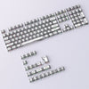 A close-up view of a full set of translucent PBT keycaps with side printing in a cherry profile layout.
