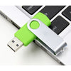 A bright green metal USB 2.0 flash drive is plugged into a laptop side port.