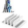 A white 3-slot vertical laptop stand organizer holding several electronic devices.